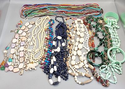 Beaded Necklaces and Bangle Bracelets. Grouping of colorful plastic beaded necklaces and bangle