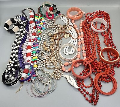 Beaded Necklaces and Bangle Bracelets. Grouping of colorful plastic beaded necklaces and bangle