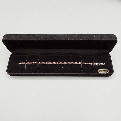 14K Tennis Bracelet with Stones. Marked 14K 7" Tennis Bracelet with Pink Tourmaline stones