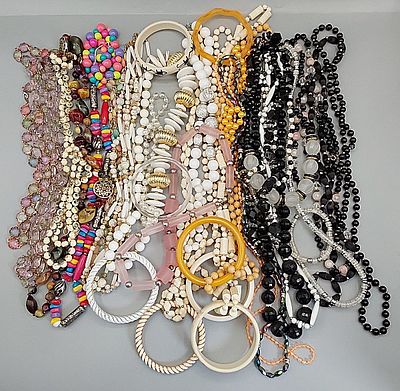 Beaded Necklaces and Bangle Bracelets. Grouping of colorful plastic beaded necklaces and bangle