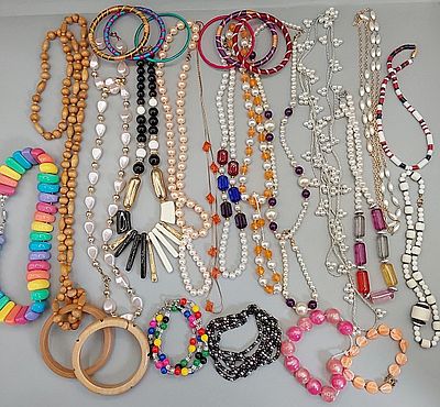 Beaded Necklaces and Bangle Bracelets. Grouping of colorful plastic beaded necklaces and bangle