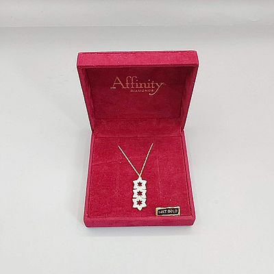 14K Gold Chain and Pendant. A marked 14K 17.5" yellow gold chain with marked 14K white and