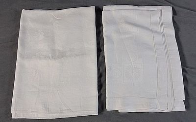 2 Vintage White Linen Damask Tablecloths. There is a white linen damask tablecloth that is 
