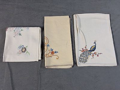 Trio of Vintage Linen with Colorful Embroidery. There is a vintage white linen cloth that 
