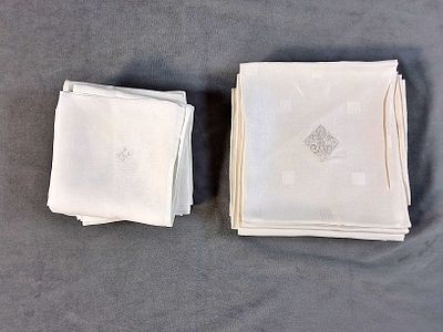 2 Sets of Monogrammed Napkins. There is a set of 7 white napkins that are monogrammed with the 