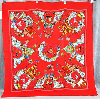 Gucci Silk Scarf. This is a red Gucci silk scarf made in Italy. On the corner, the brand's name 