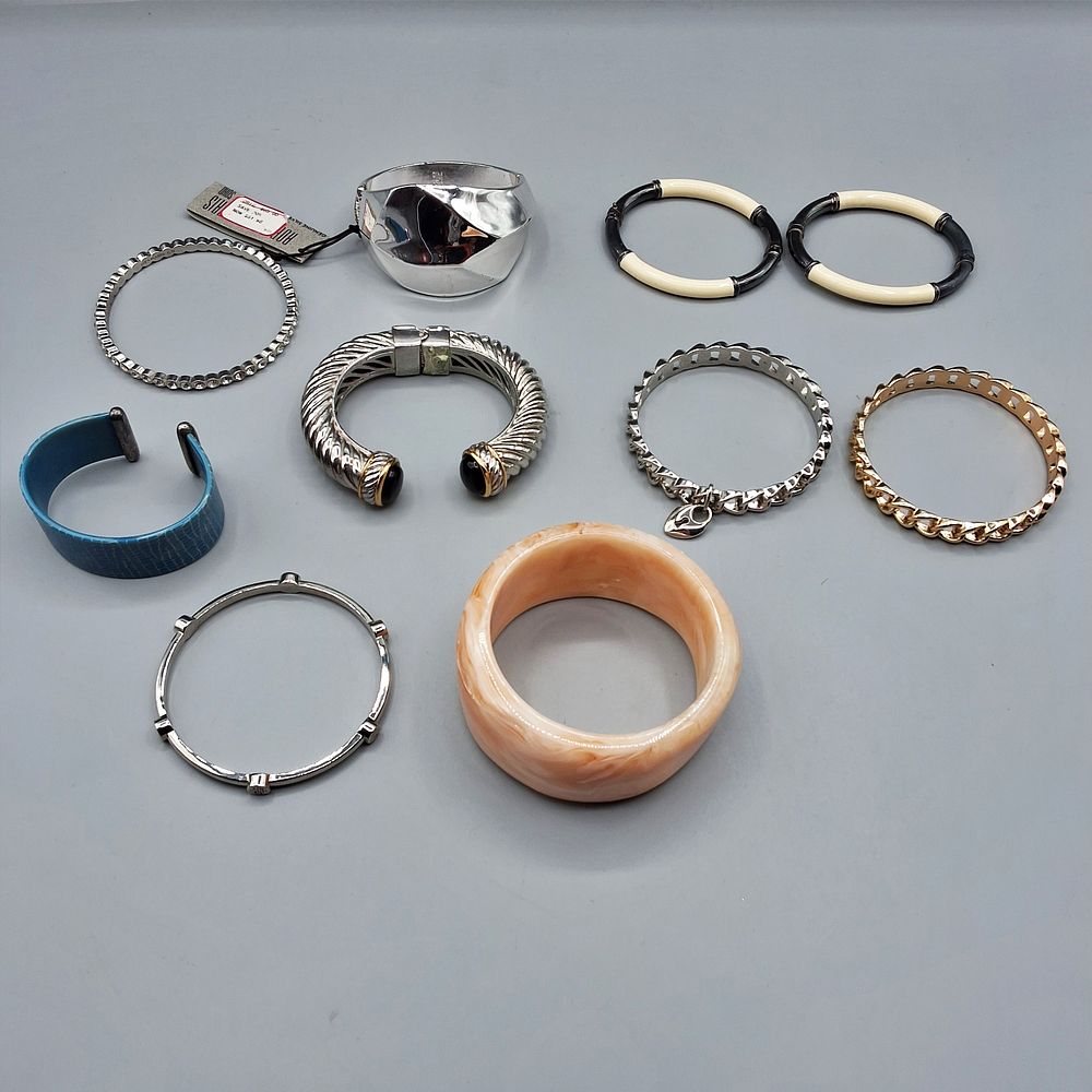 Lot 166: 11 Gold and Silver Toned Bracelets