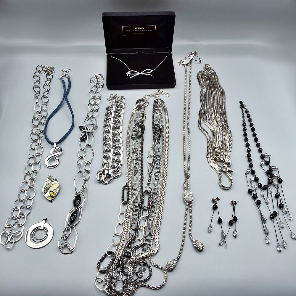Lot 173: 9 Silver Toned Necklaces - Pendants Included