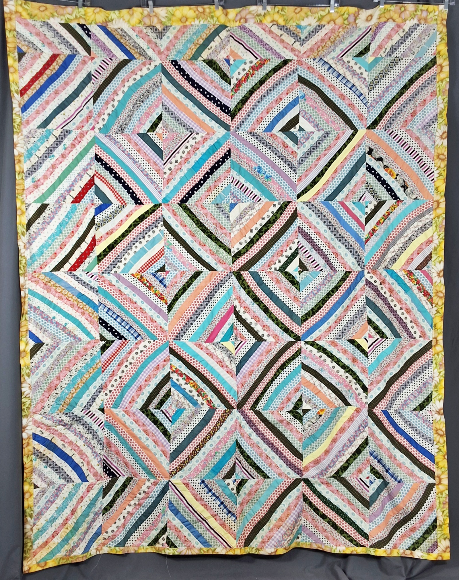 Vintage c1960 String Pieced Summer Quilt measuring 73 by 93 inches. It is comprised of 42 blocks, 11.5 by 11.5 inches, set straight, 6 by 7,