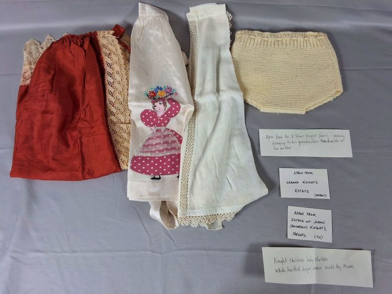 Lot 9: 3 Aprons and Knit Diaper