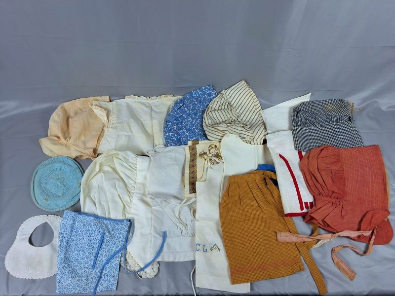 Lot 21: Group of 17 Bonnets, Aprons, and More