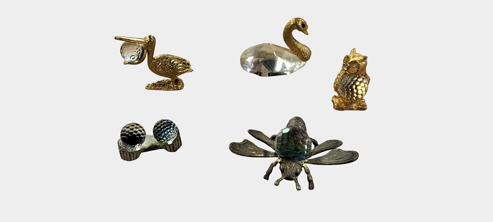 Lot 483: An Assortment of Miniature Faceted Crystal and Plated Metal Figurines