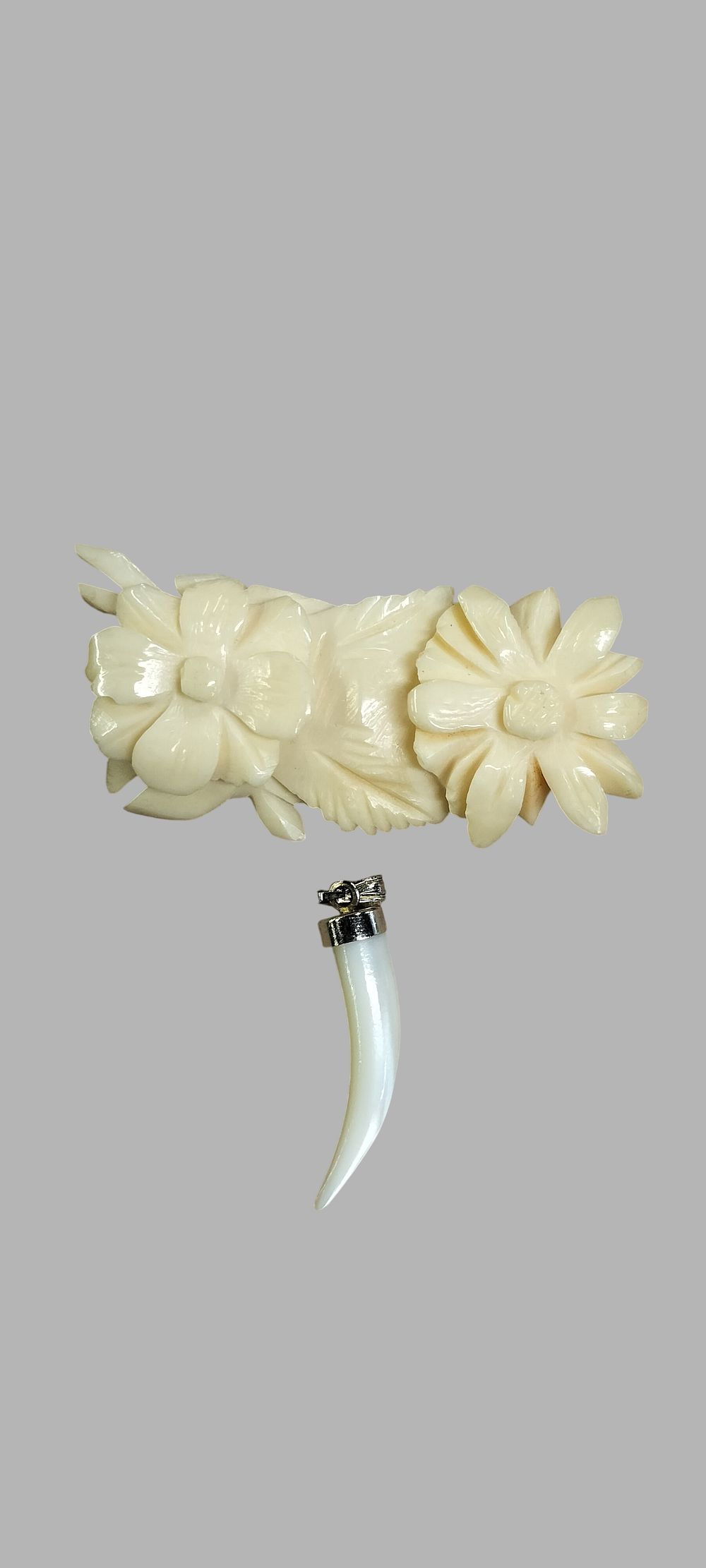 Lot 396: Two Items of Vintage Jewellery Comprising a Carved Floral Brooch and a Mother-of-Pearl Tusk Pendant