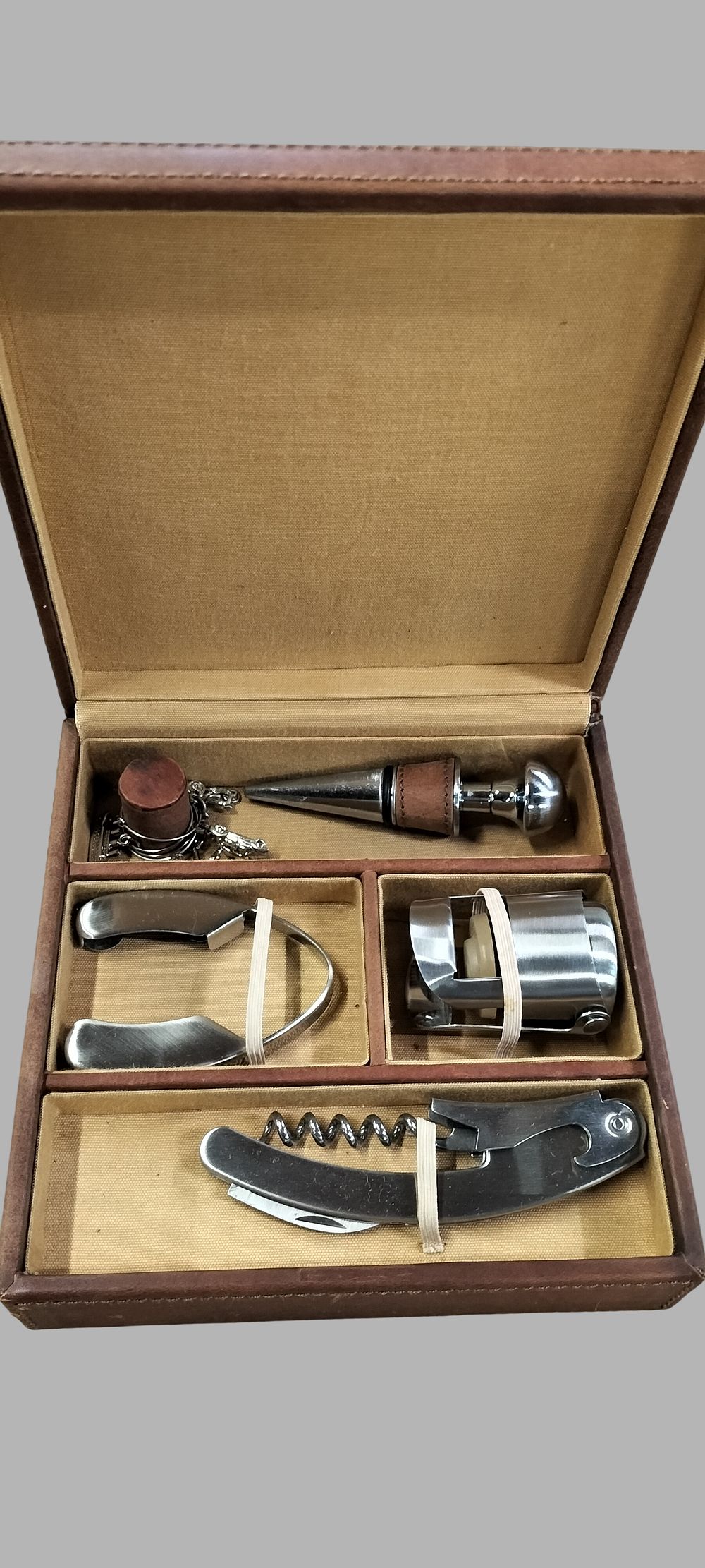 Lot 453: A Fossil Leather-Cased Wine Accessory Set