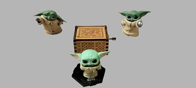A Collection of Star Wars The Child Grogu Figures and Mechanical Music Box