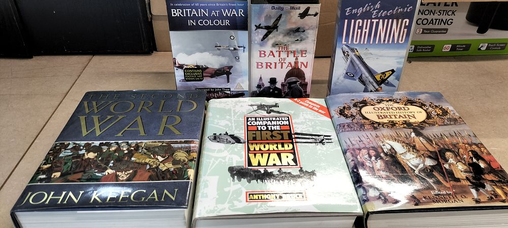 Lot 289: A Collection of Military and British History Hardcover Books and VHS Video Cassettes