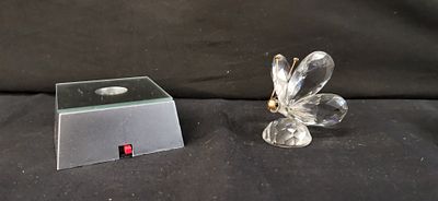 Two items comprising a faceted clear crystal butterfly figurine and an illuminated display stand