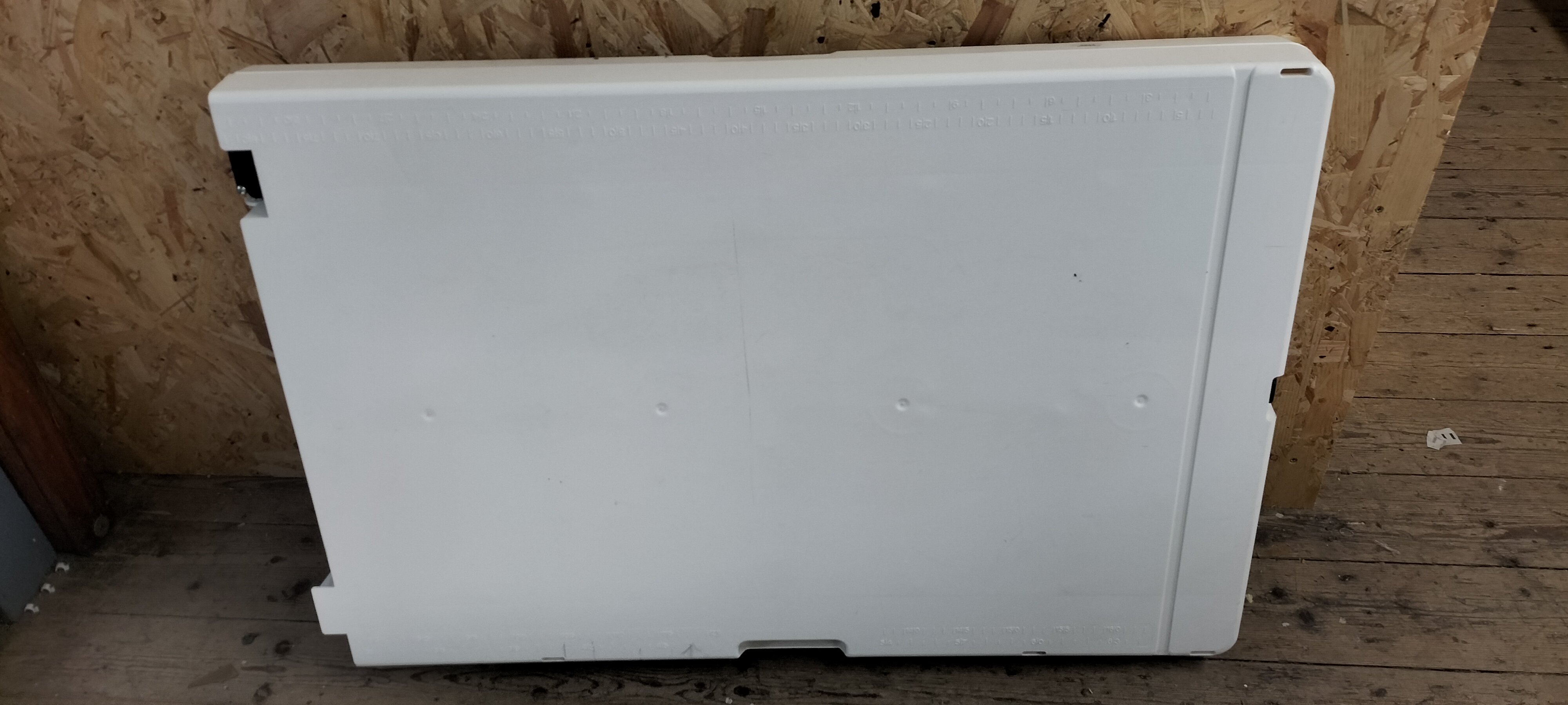 A White Plastic Folding Decorating Table with Storage for Legs