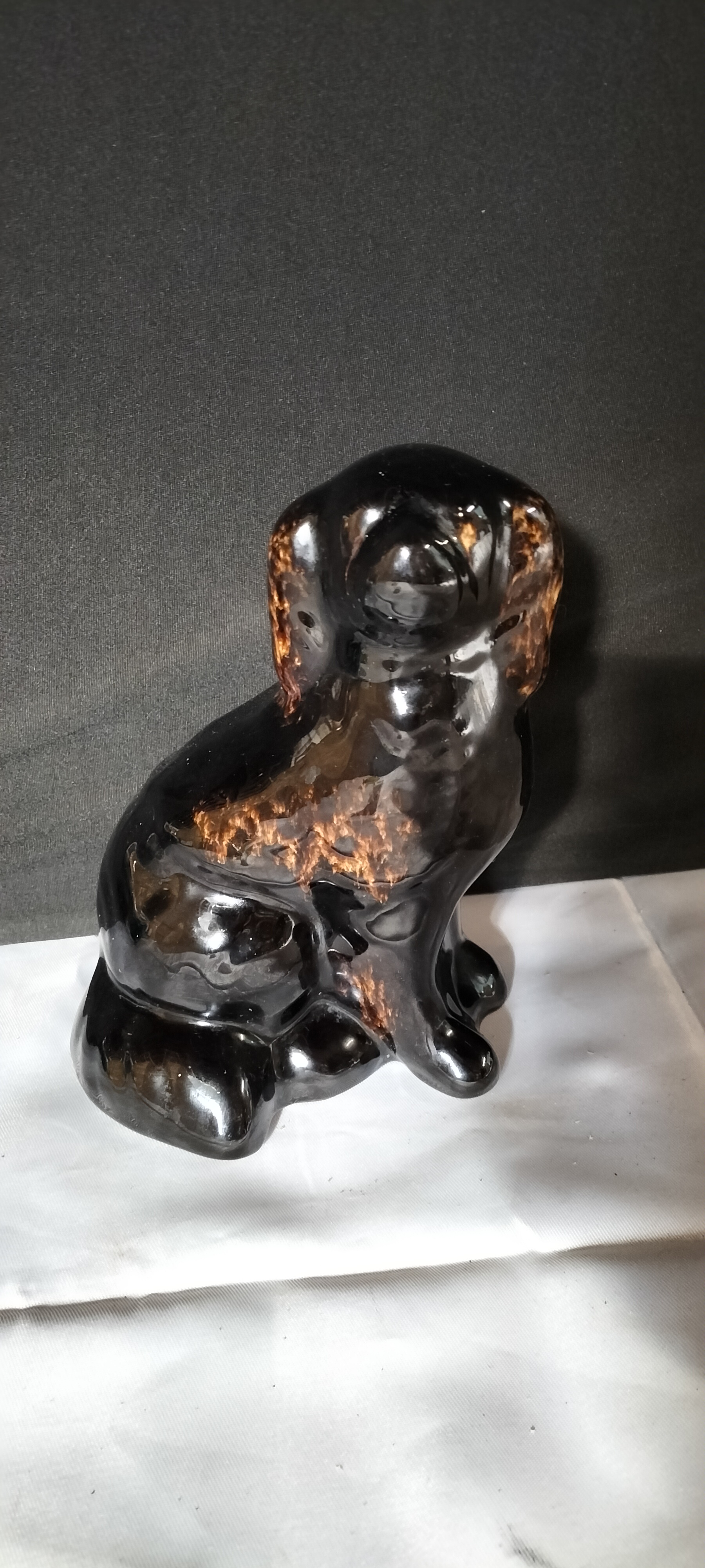 A Vintage Black and Brown Glazed Ceramic Spaniel Figurine