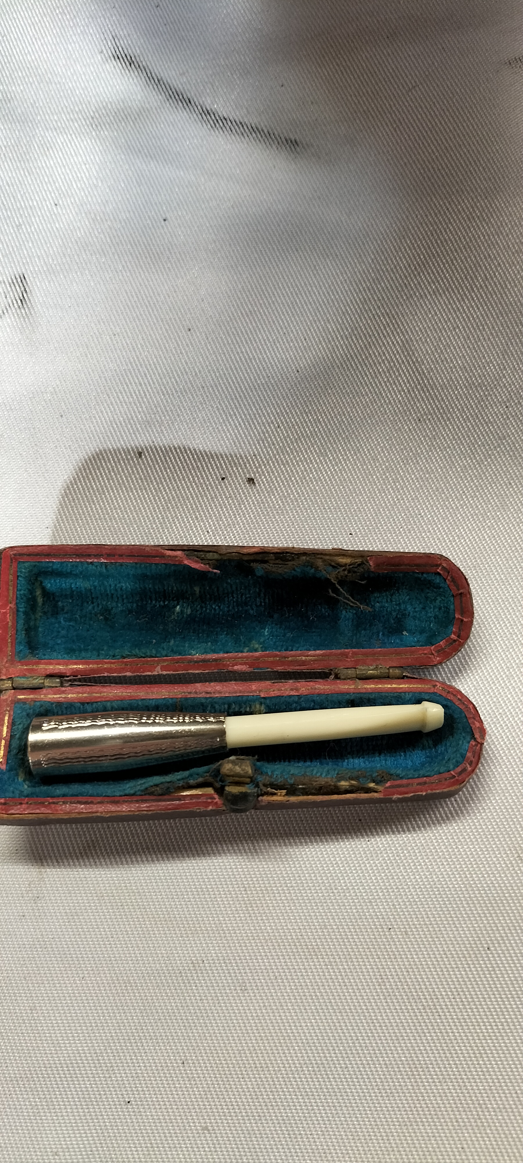 A Vintage Gold Tone and Cream Mouthpiece Cigarette Holder in a Fitted Case