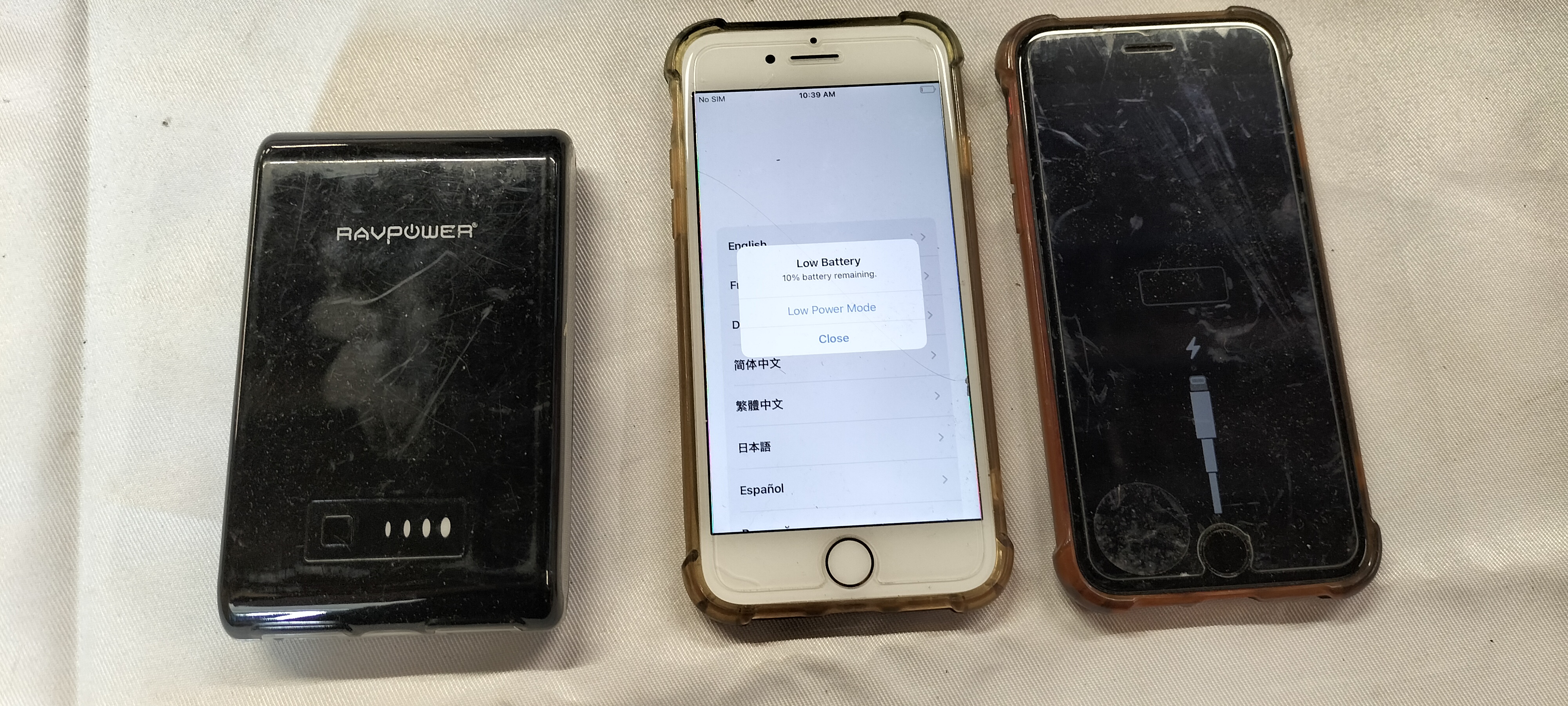 2 Apple iPhone 7 Model A1778 Smartphones and a RAVPower RP-PB07 Power Bank