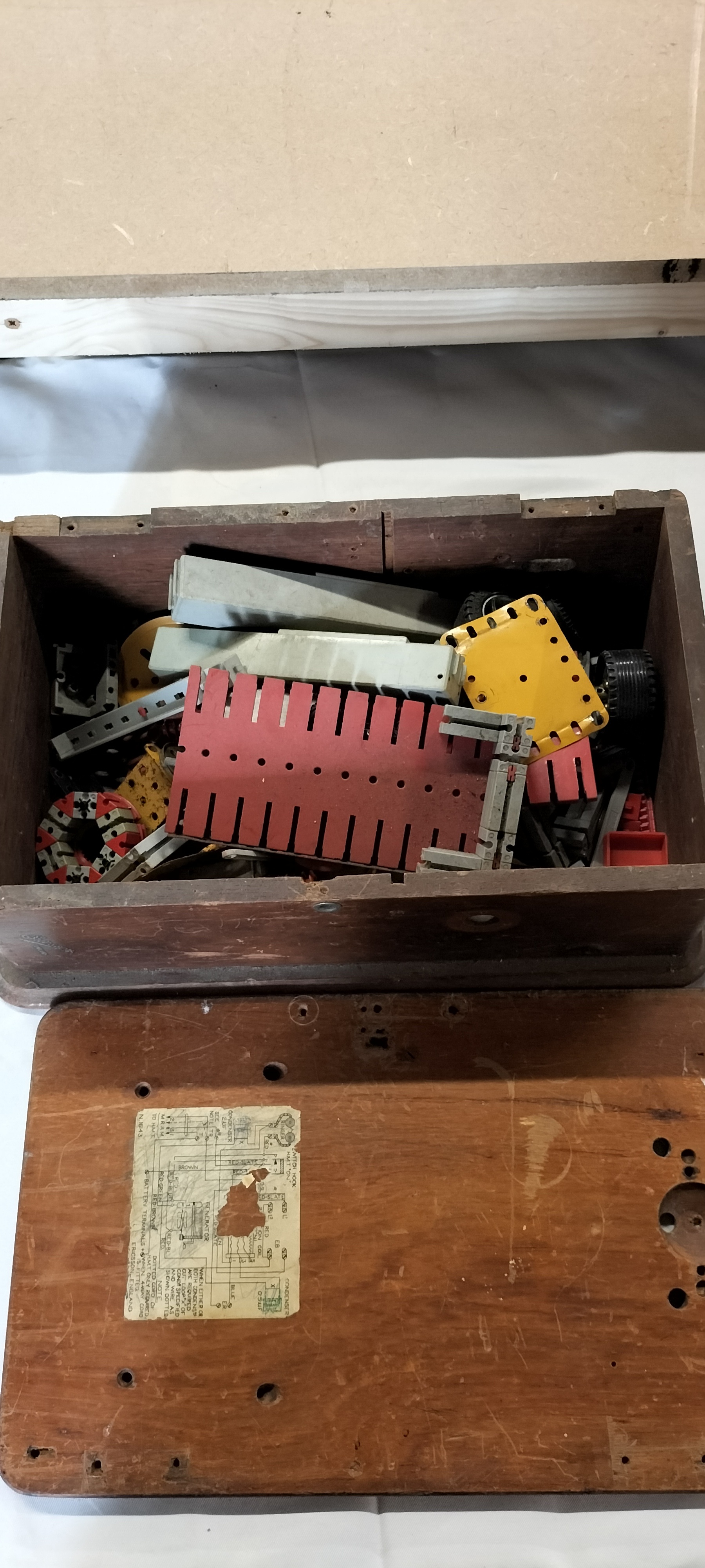 A Collection of Metal and Plastic Construction Components in an Ericsson ENGLAND Telephone Box, N. 1043