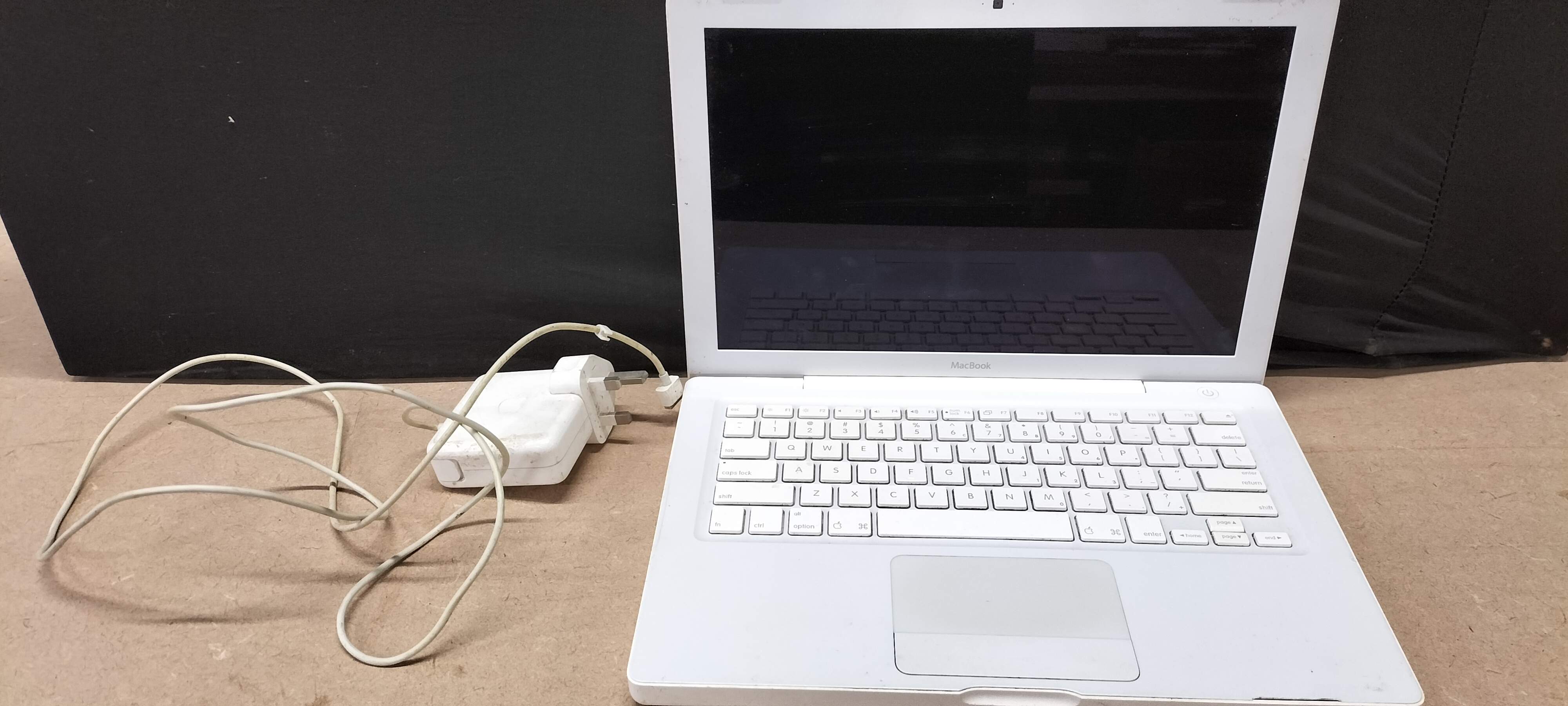 A White Polycarbonate Apple MacBook Laptop with MagSafe Power Adapter