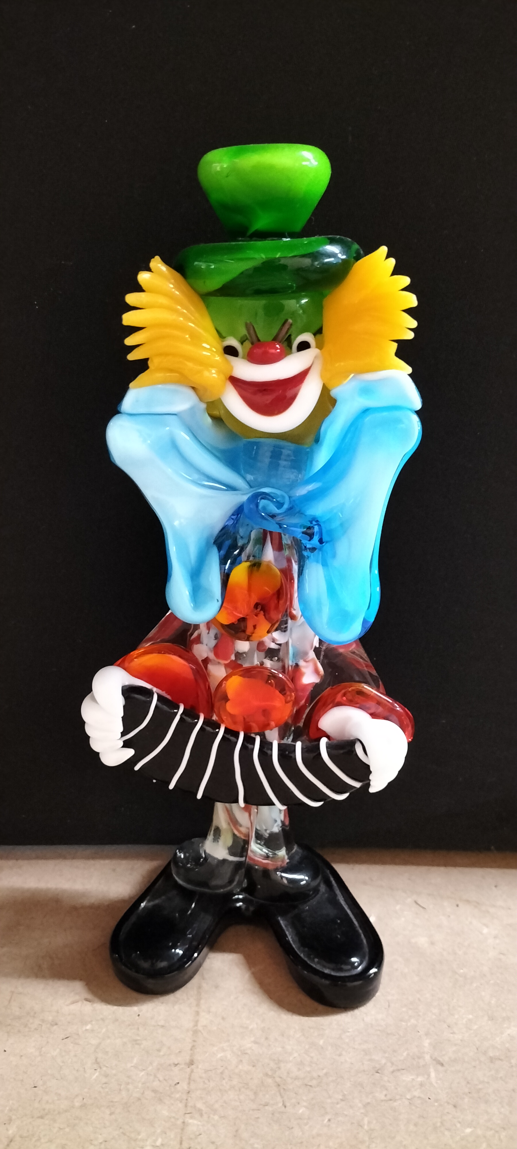 A Murano Style Multi-coloured Art Glass Clown Playing a Concertina