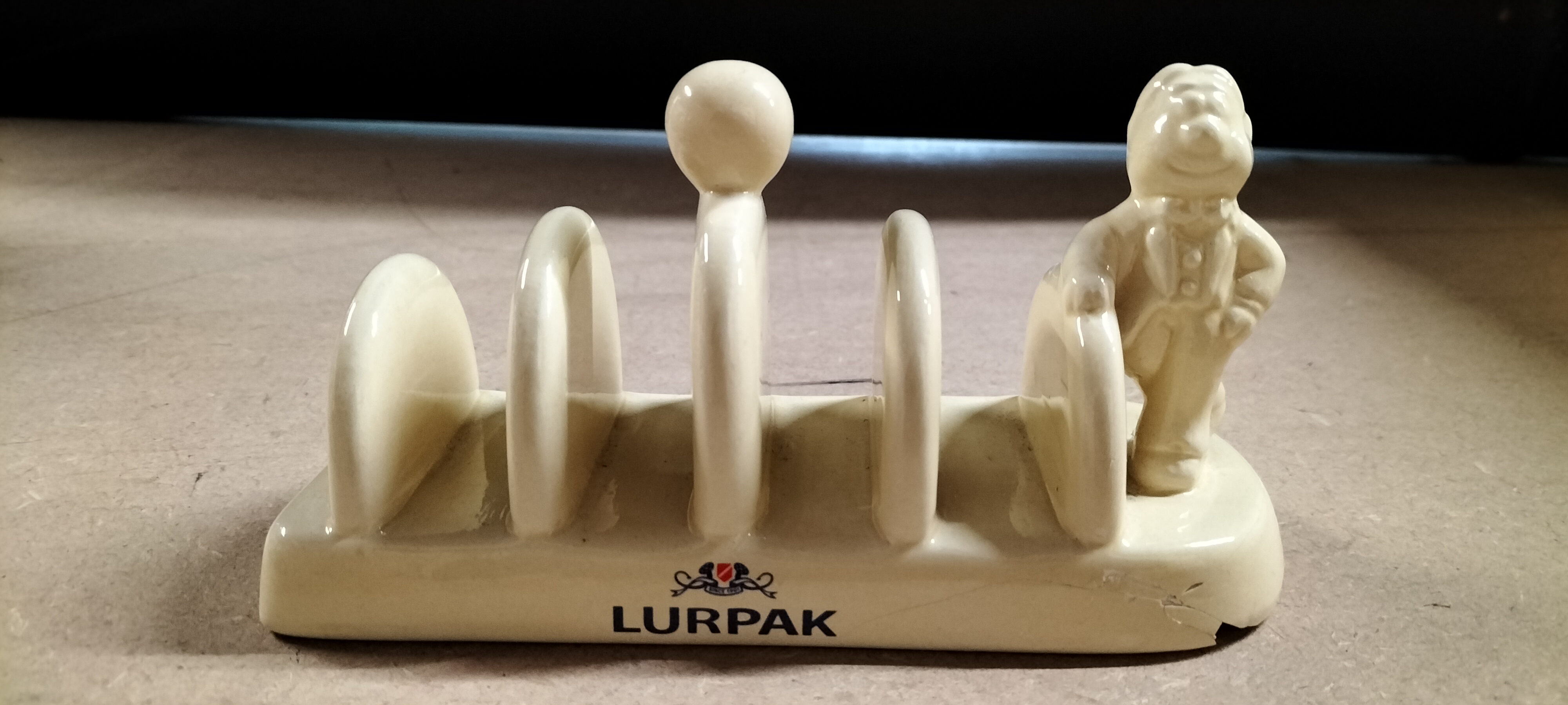 A Lurpak Ceramic Toast Rack with Character Figurine