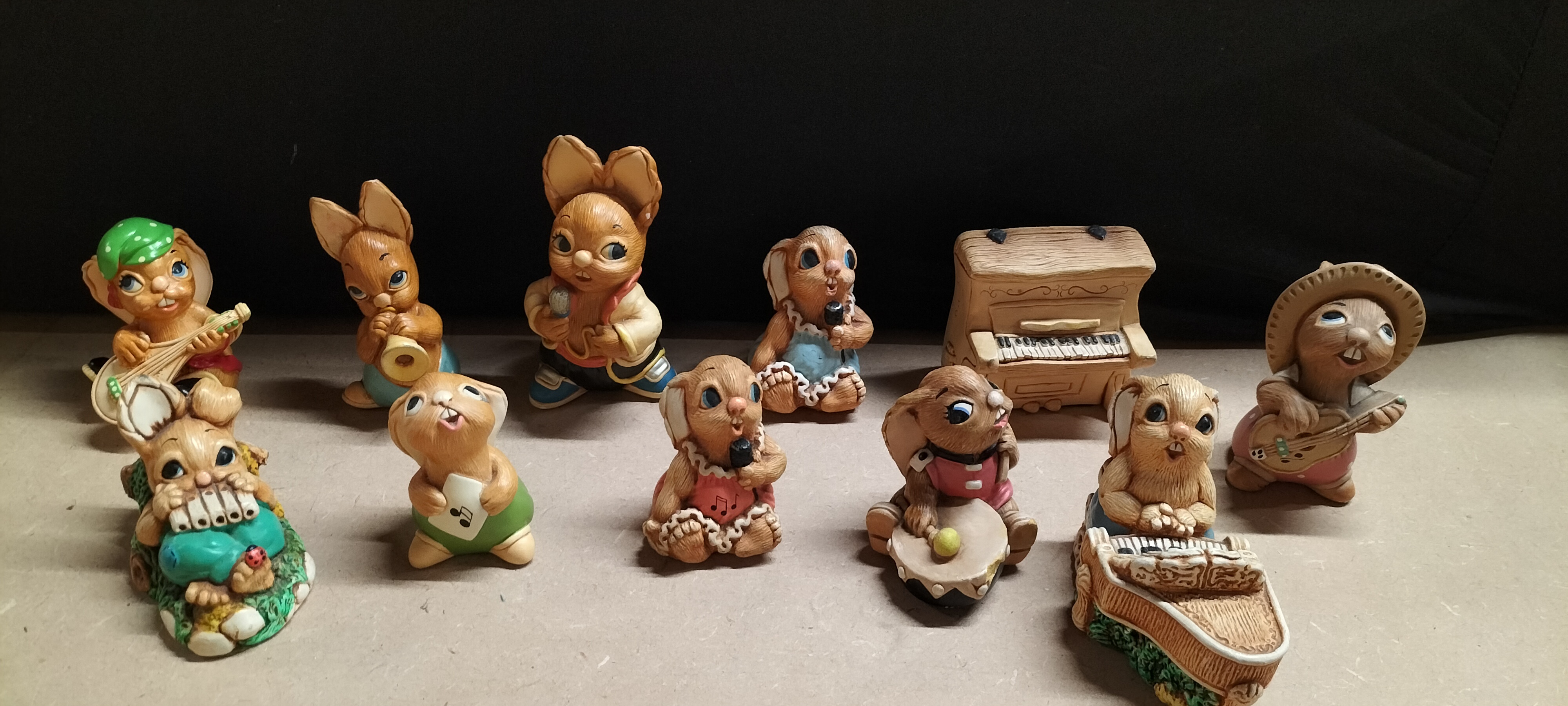 A Collection of 11 Pendelfin Style Composite Musical Rabbit Figurines