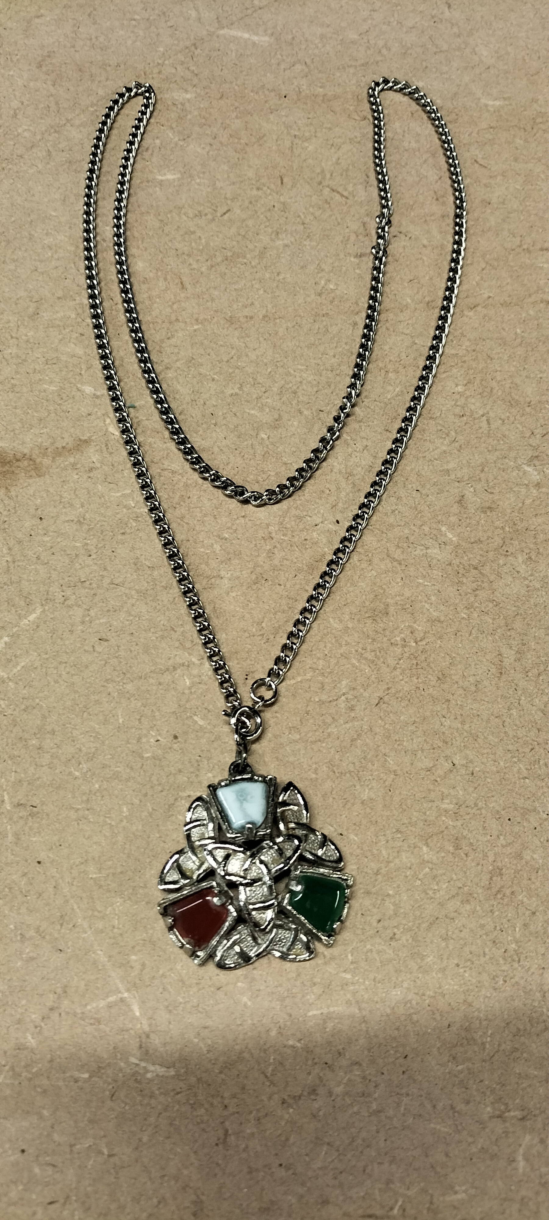 A Silver Tone Trinity Knot Pendant Necklace With Three Coloured Insets