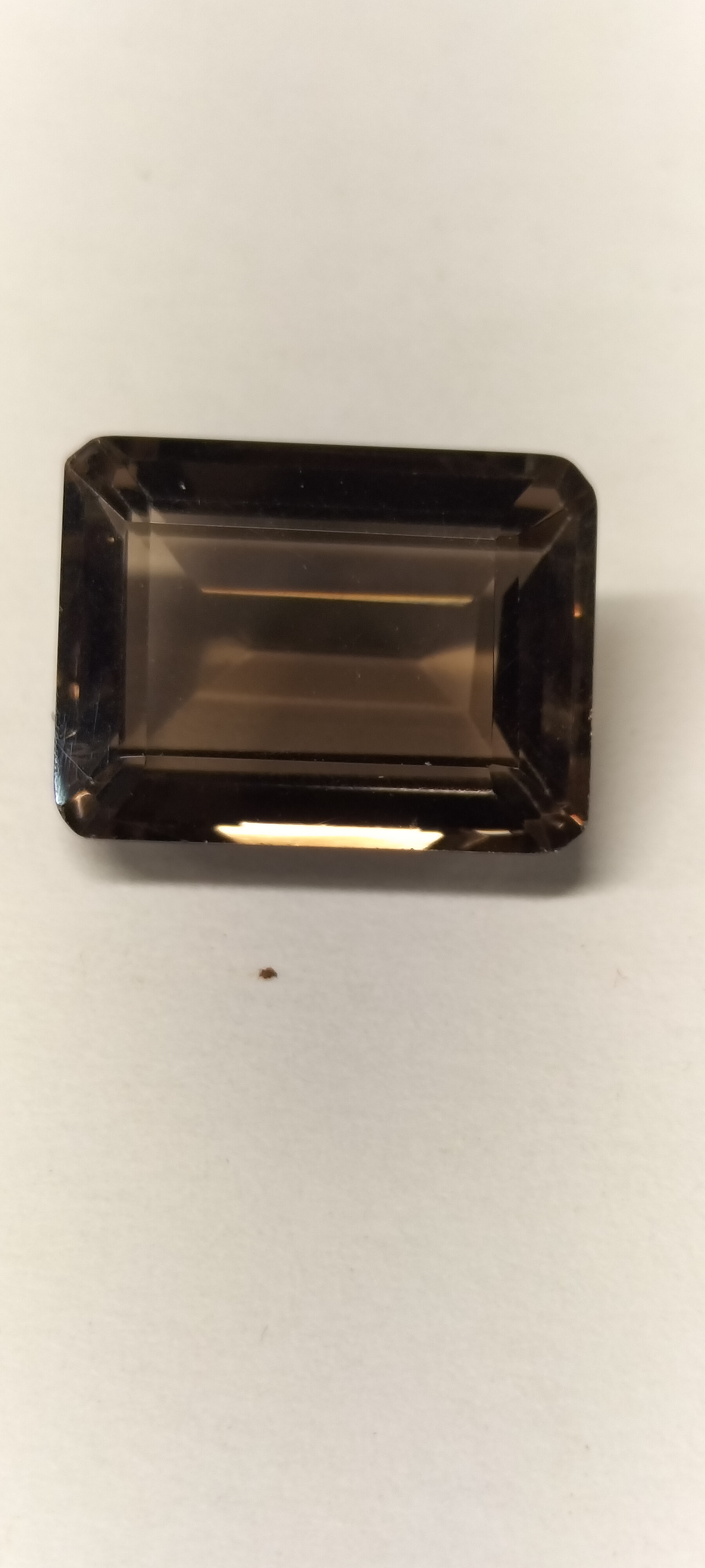 A Single Faceted Emerald Cut Chocolate Topaz Gemstone. 11.85 ct