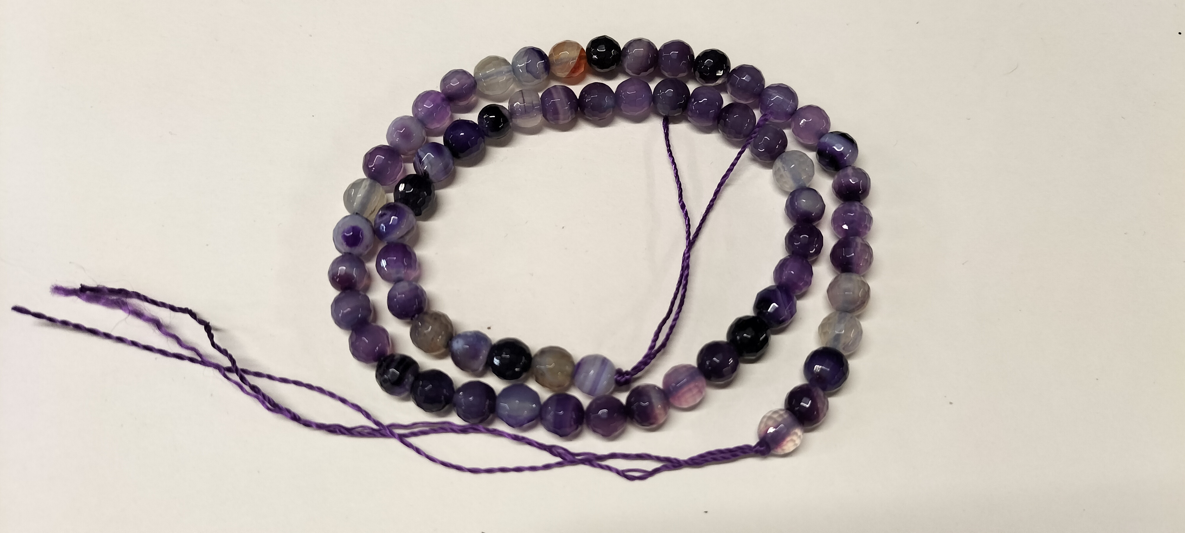 An Assortment of Faceted Dyed Banded Amethyst Gemstone Beads. 94.55ct