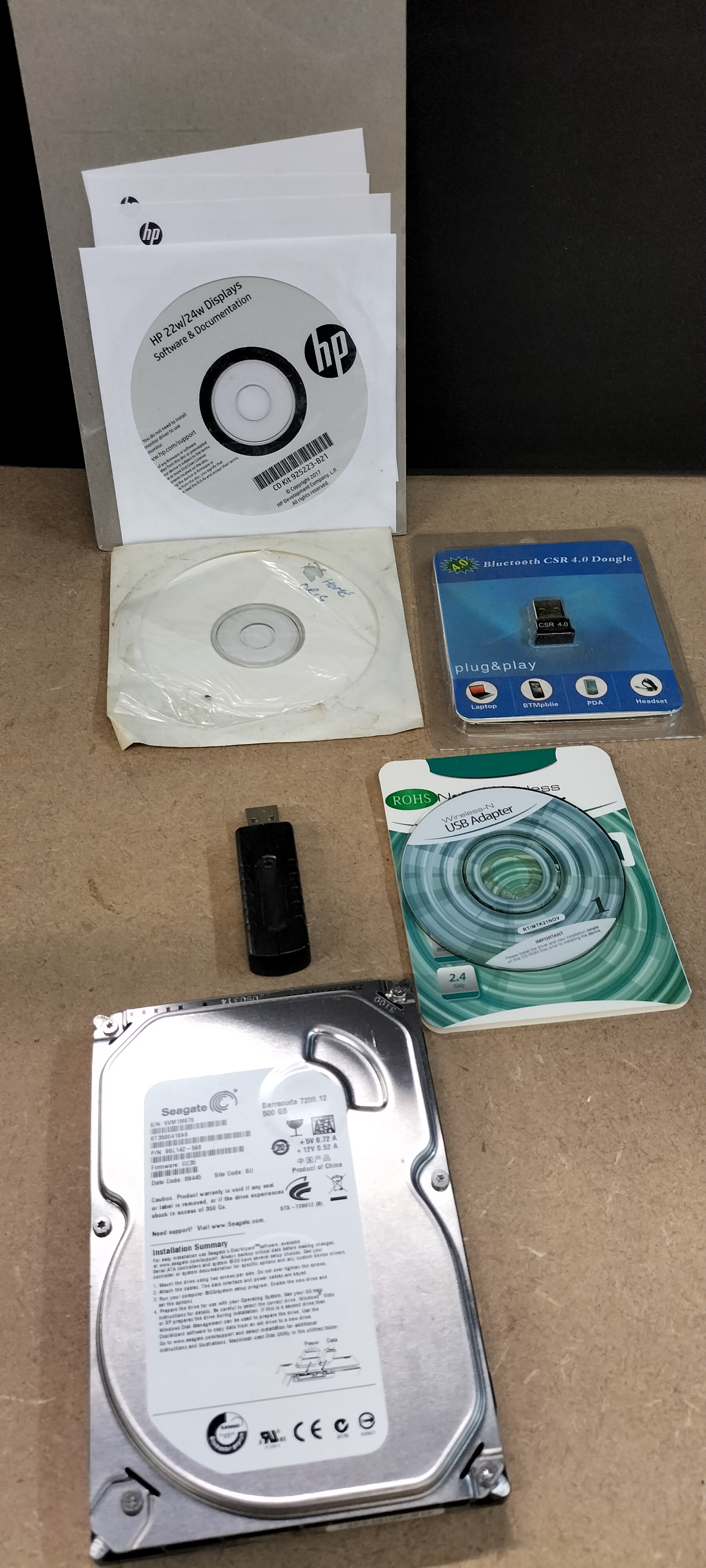 A Collection of 6 Computer Peripherals including a Seagate Barracuda 500 GB Hard Drive, ST3500418AS