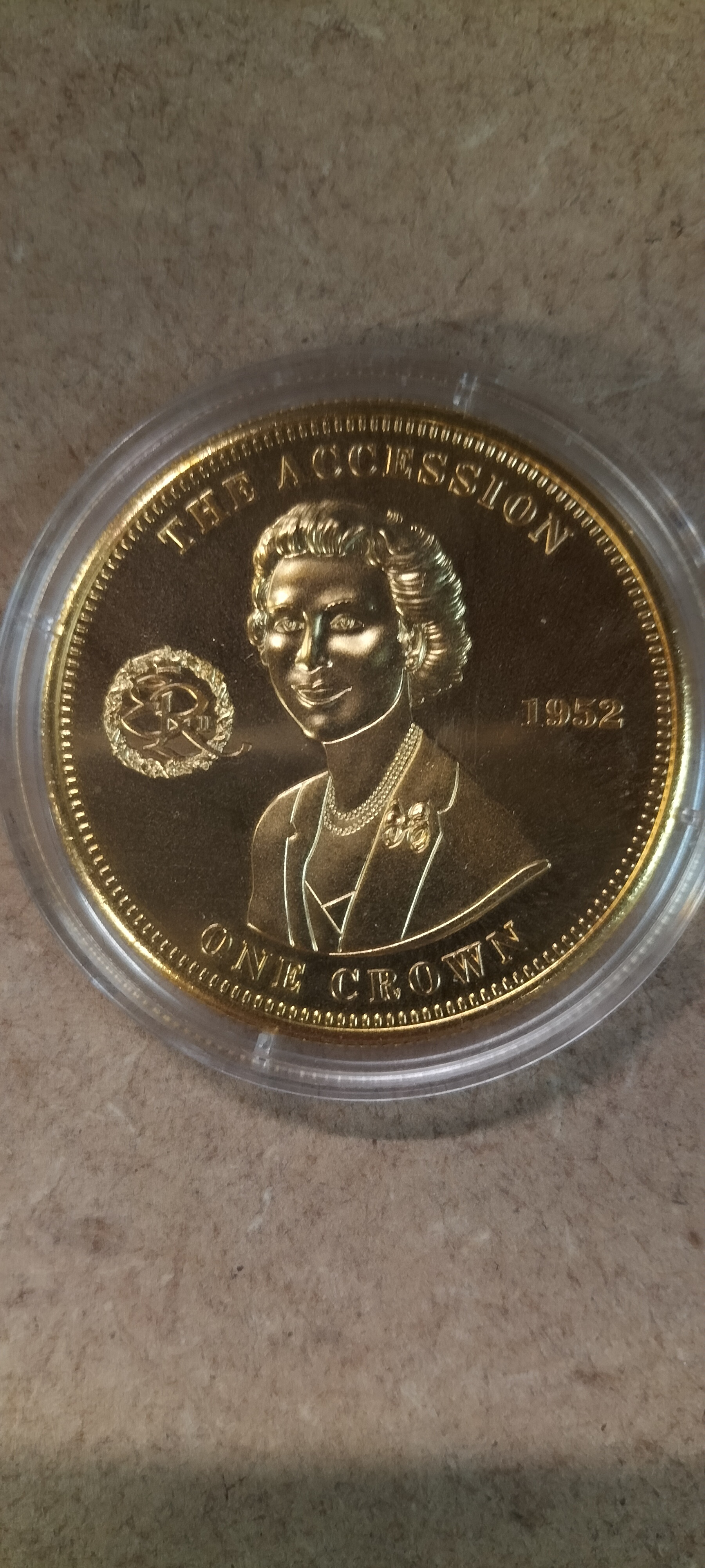 A 2010 TDC Gold Toned The Accession One Crown Commemorative Coin