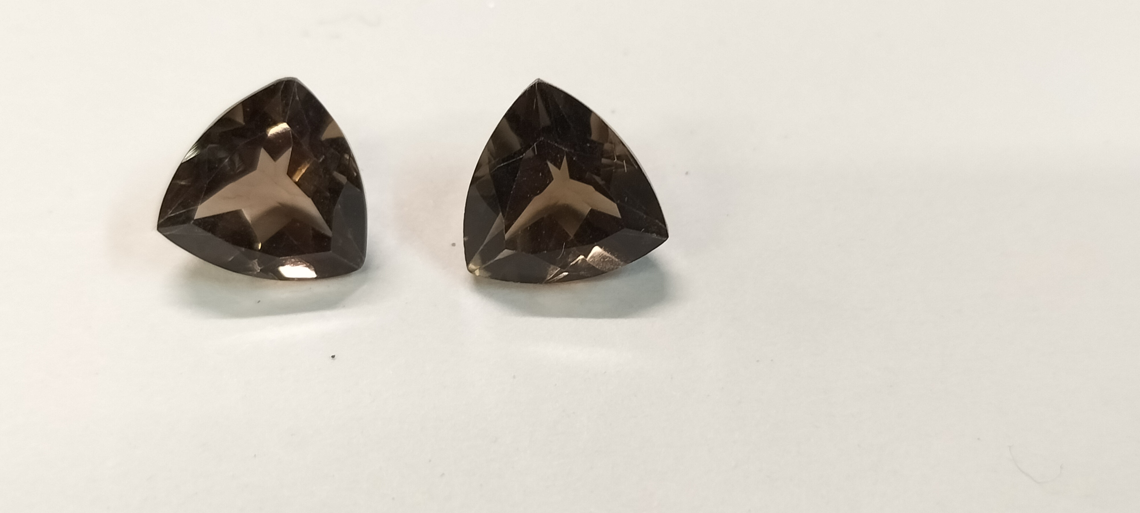 A 6.65ct Pair of Faceted Trillion Cut Smoky Topaz Gemstones