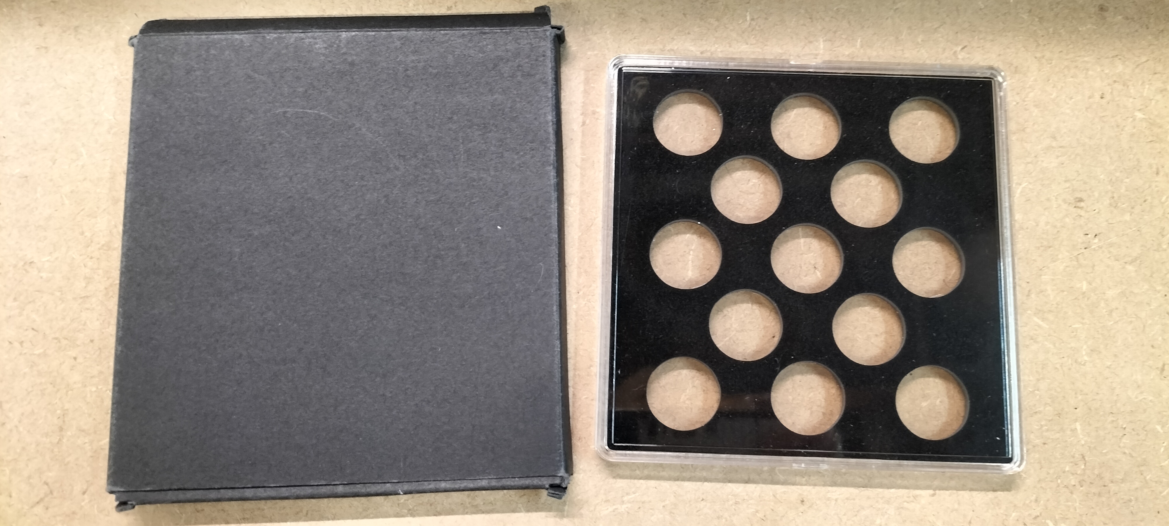 A Plastic Coin Storage Case and Cardboard Sleeve