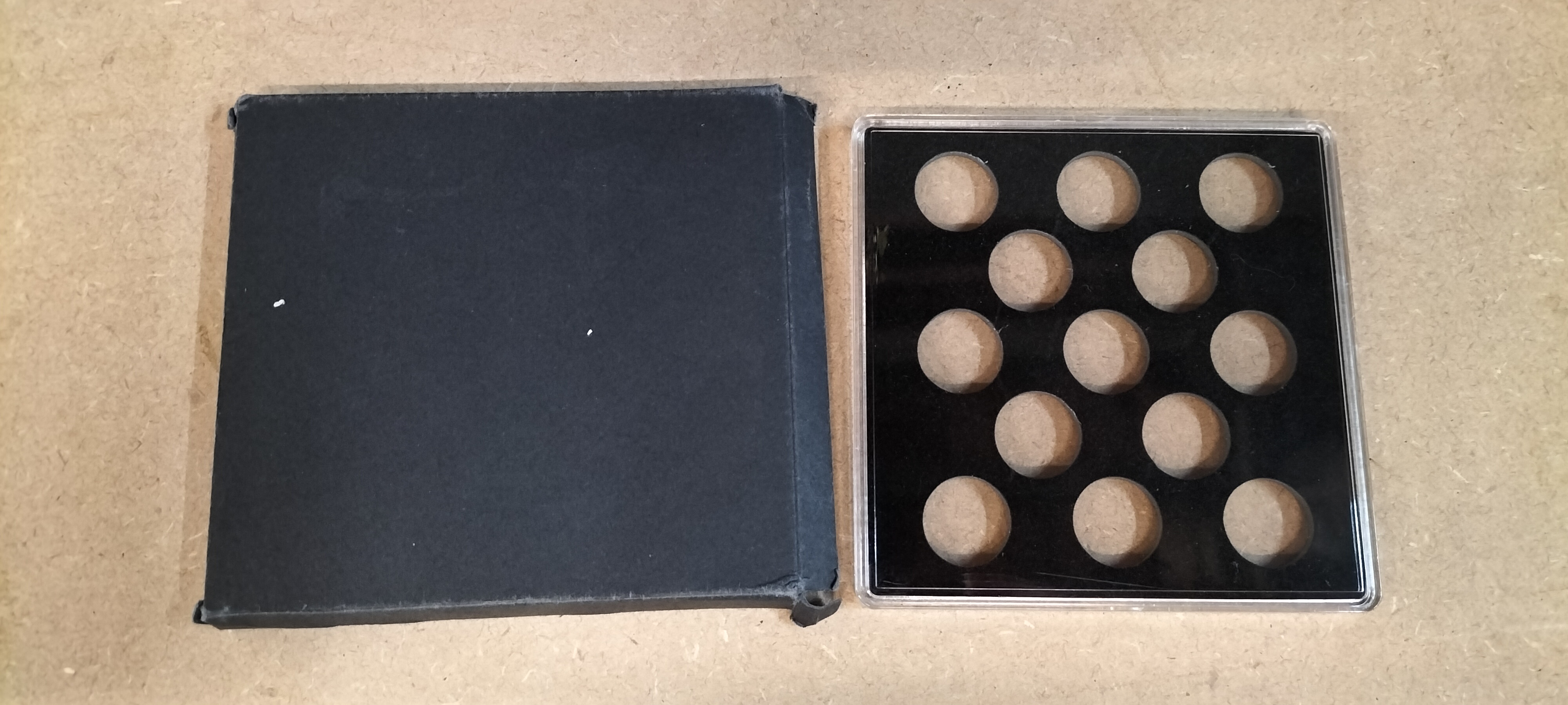 A Plastic Numismatic Display Case and Black Cardboard Sleeve