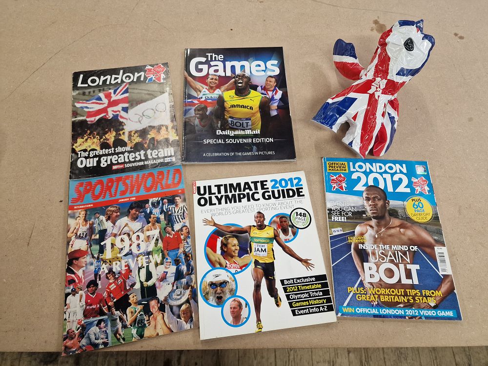 Lot 491: A Collection of 6 London 2012 Olympic Games Souvenir Magazines and Inflatable Mascot