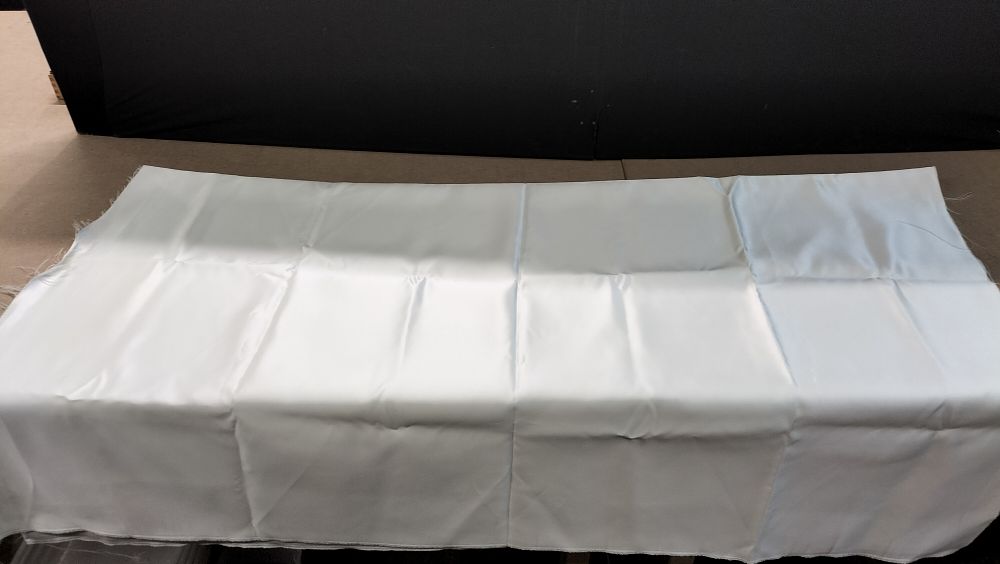 Lot 194: A Single Section of Off-White Satin Fabric Yardage