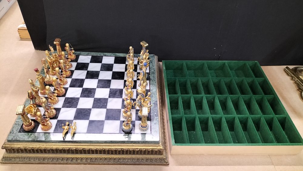 Lot 261: A Set of Franklin Mint Egyptian Themed Gold Toned and Enamelled Chess Pieces with Storage Tray. 2 Pieces Broken. And Glass Pyramid Top Missing