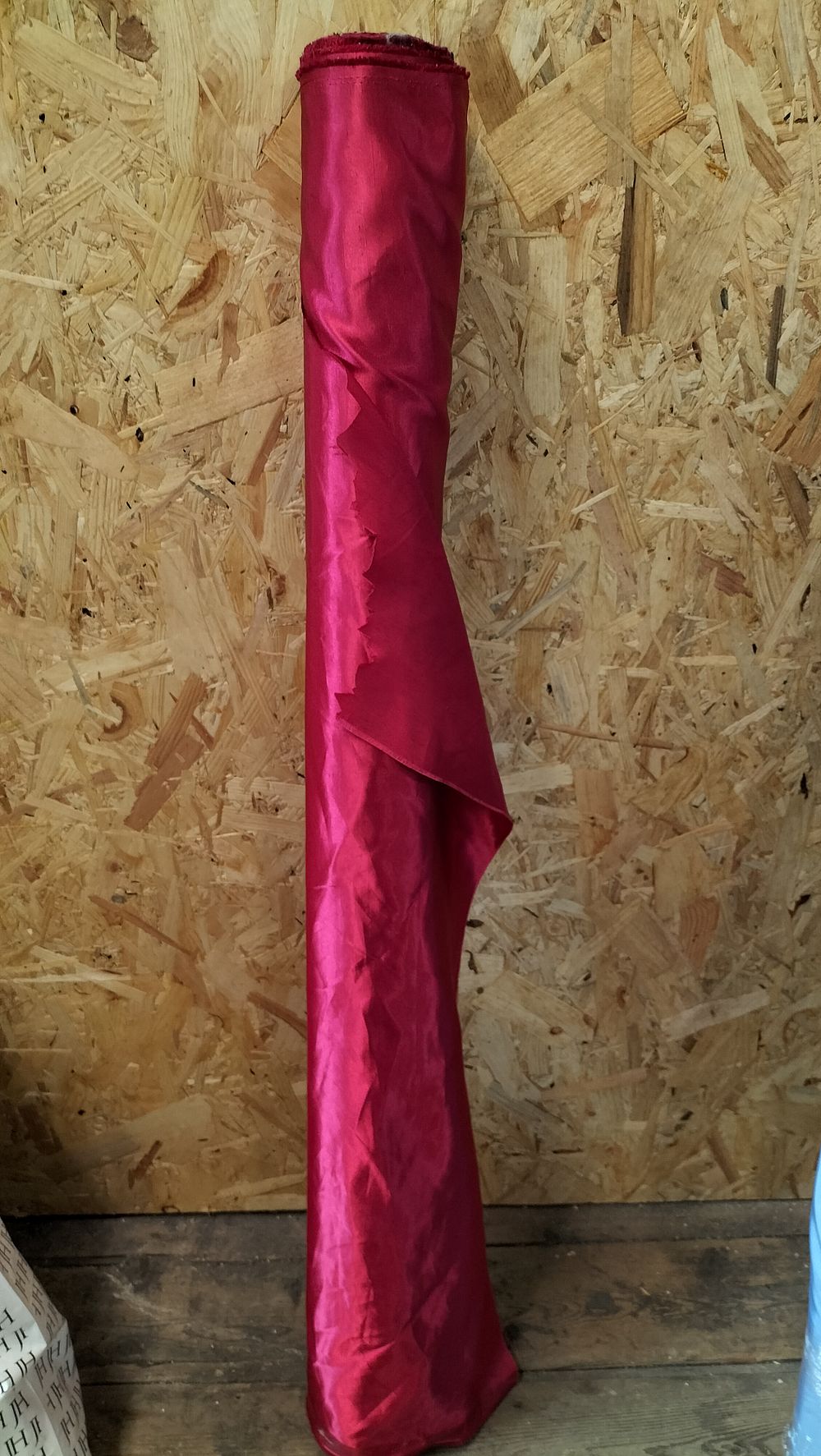 Lot 268: A Roll of Magenta Synthetic Textured Satin Fabric