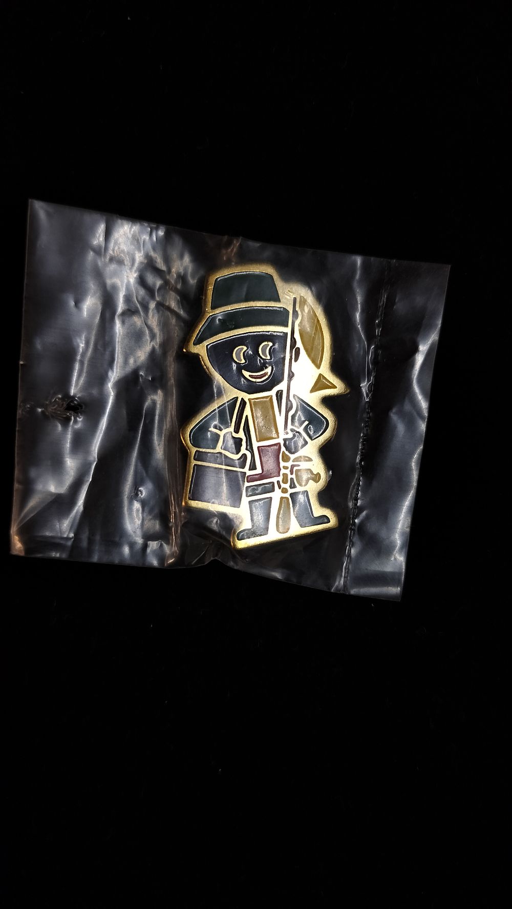 Lot 278: A James Robertson & Sons Enamel Golly Fisherman Badge