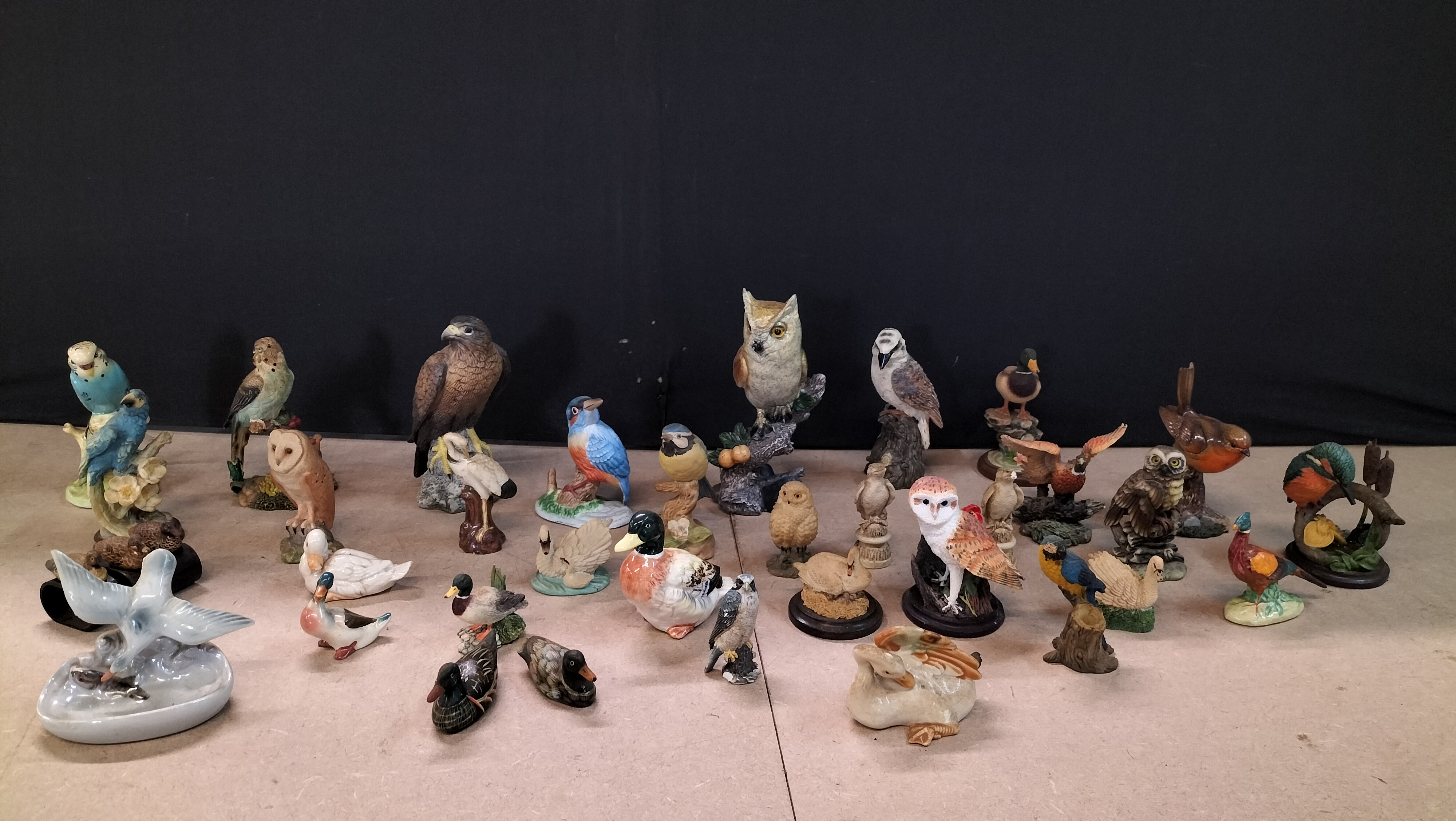 A Collection of 35 Glazed Porcelain, Bisque, and Resin Bird Figurines