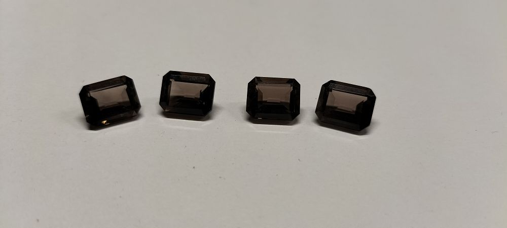 Lot 316: A Collection of 4 Smoky Topaz Emerald Cut Faceted Gemstones 5.80 ct