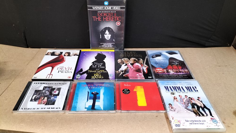 Lot 151: An Assortment of 7 DVD and VHS Titles and 3 Music CDs