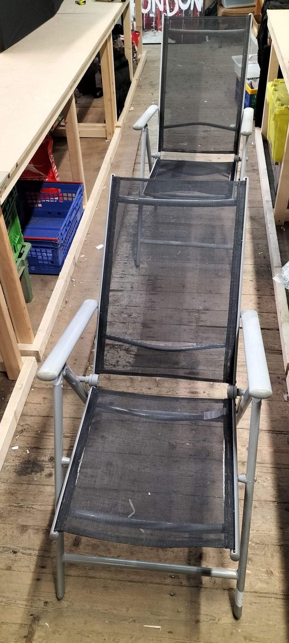 Lot 190: A Pair of Grey Powder Coated Metal and Black Mesh Reclining Garden Chairs