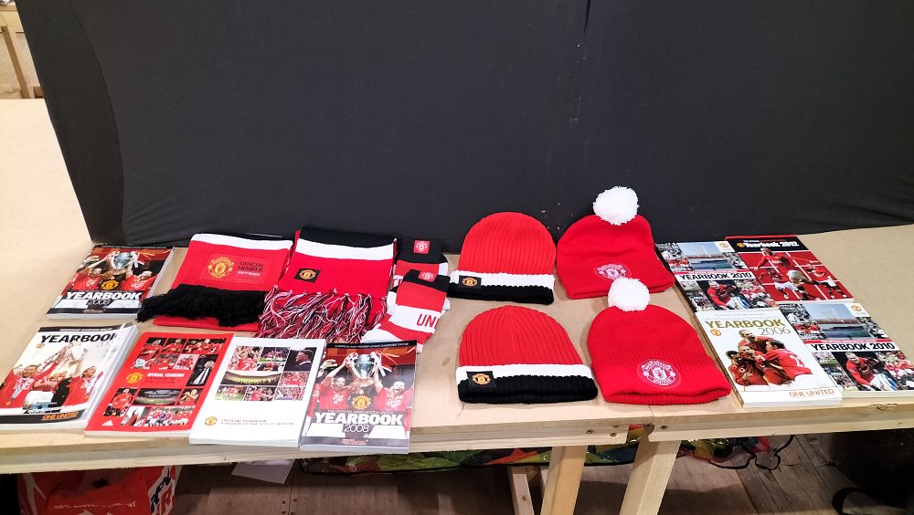 Lot 202: An Assortment of Manchester United Football Club Official Yearbooks and Supporters Apparel