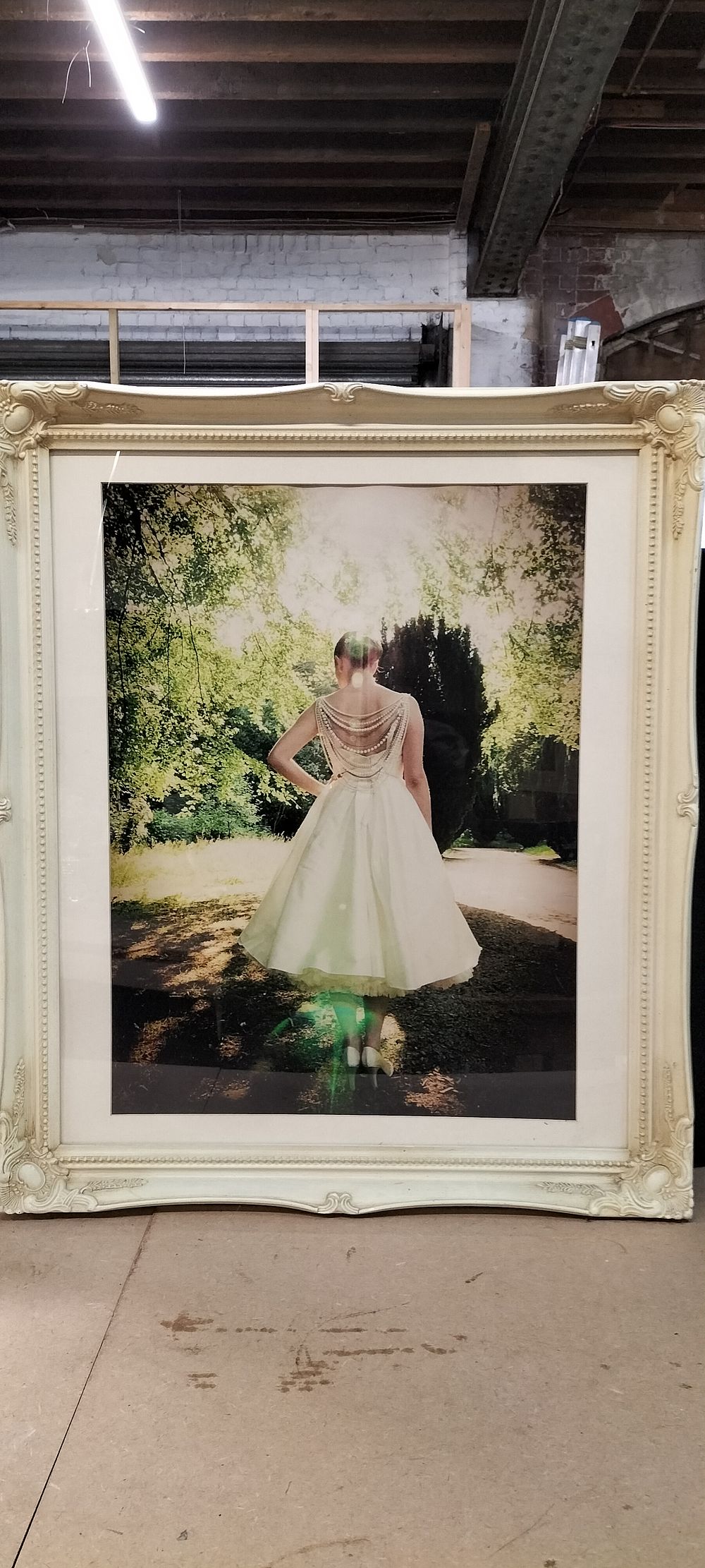 Lot 235: A Large Framed Colour Photographic Print of a Woman in a Vintage Style Wedding Dress