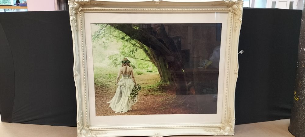 Lot 236: A Framed Colour Print of a Bride in a Woodland Setting